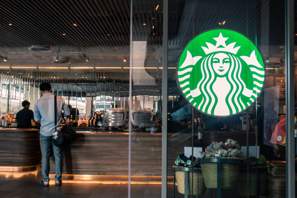 Inside of a coffee shop with Starbucks logo on the glass door.

Picture by Wachiwit.