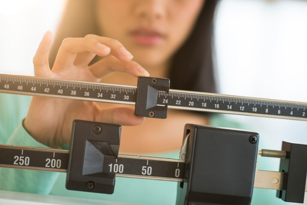 Midsection Of Woman Adjusting Weight Scale
By tmc_photos